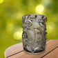 Decorative candle holder with leaf and berry design on a wooden surface with a blurred green background | oak7west.com