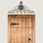 Leaf and Fleur de Lis Iron Monogram Wall Grille - Monogrammed Wall Decor (46.5"W) shown hung over rustic wood door with iron hardware | oak7west.com