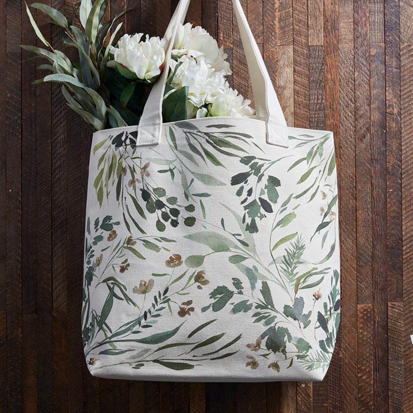 Green leaf design on tote bag with flowers on a dark wood background | Canvas Tote Bag with Inside Zippered Pocket - Loved | oak7west.com