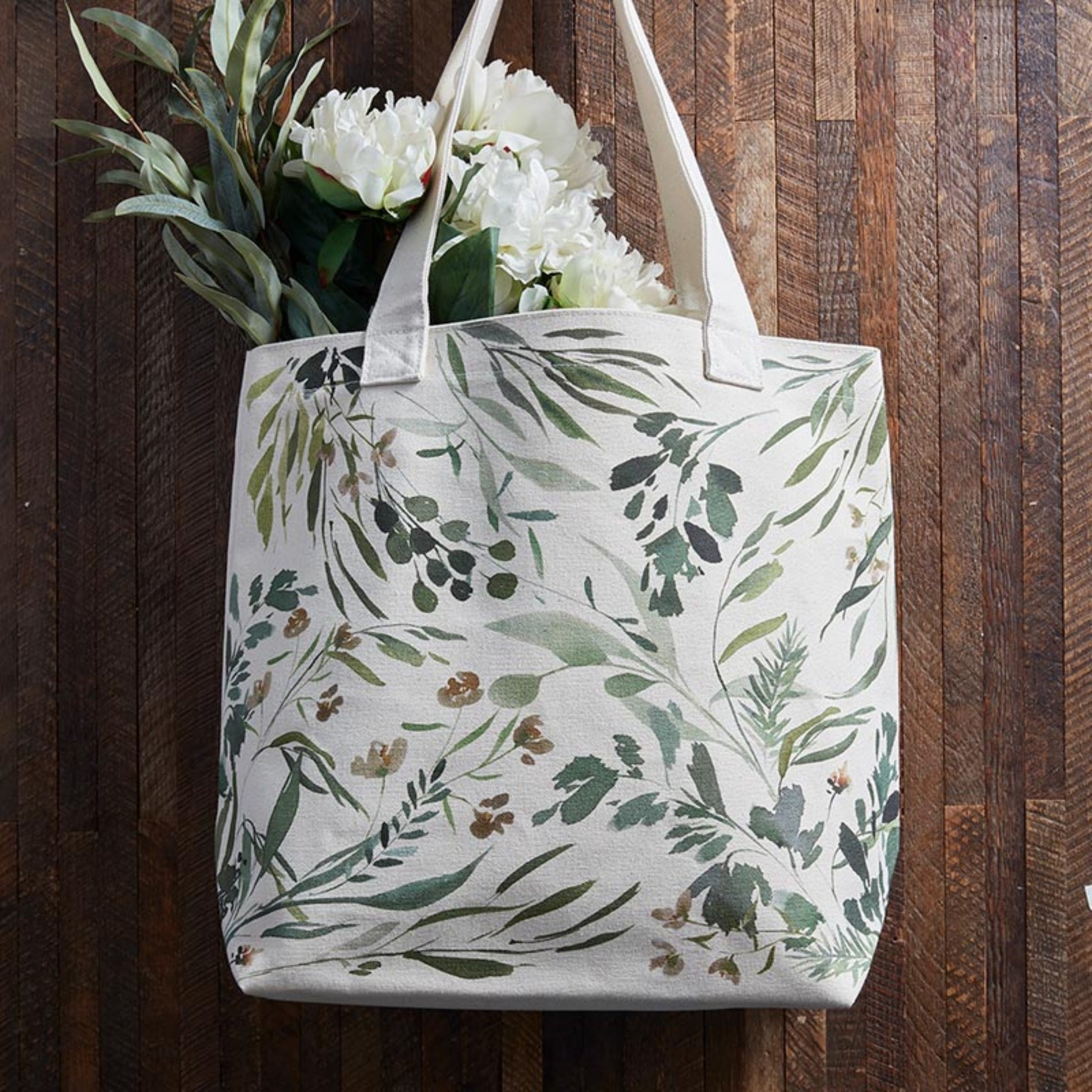Green leaf design on tote bag with flowers on a dark wood background | Canvas Tote Bag with Inside Zippered Pocket - Loved | oak7west.com