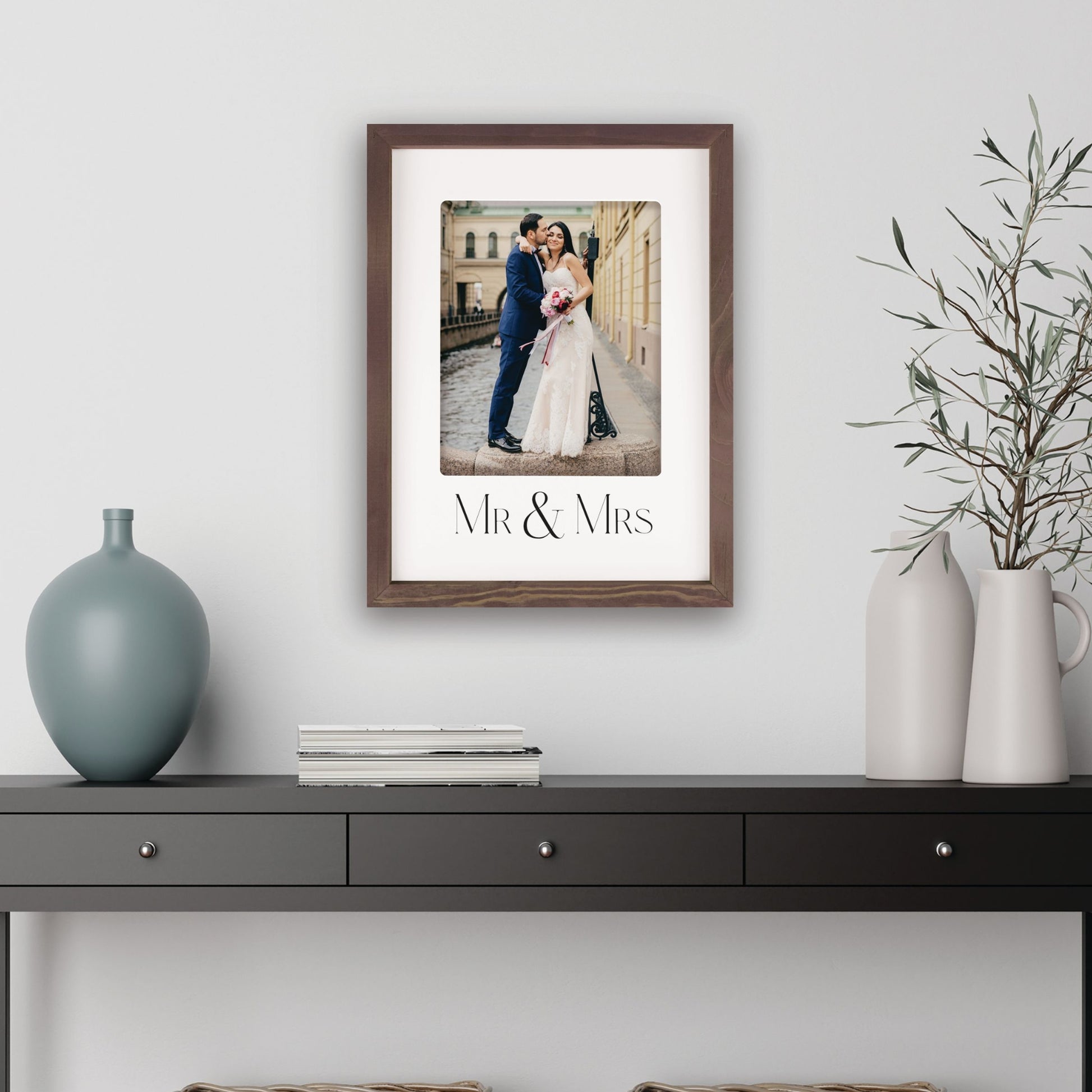Framed photograph of a couple with 'Mr & Mrs' text on a wall above a console table | Mr & Mrs Photo Frame - Wedding gift - Rustic Wood Frame | oak7west.com