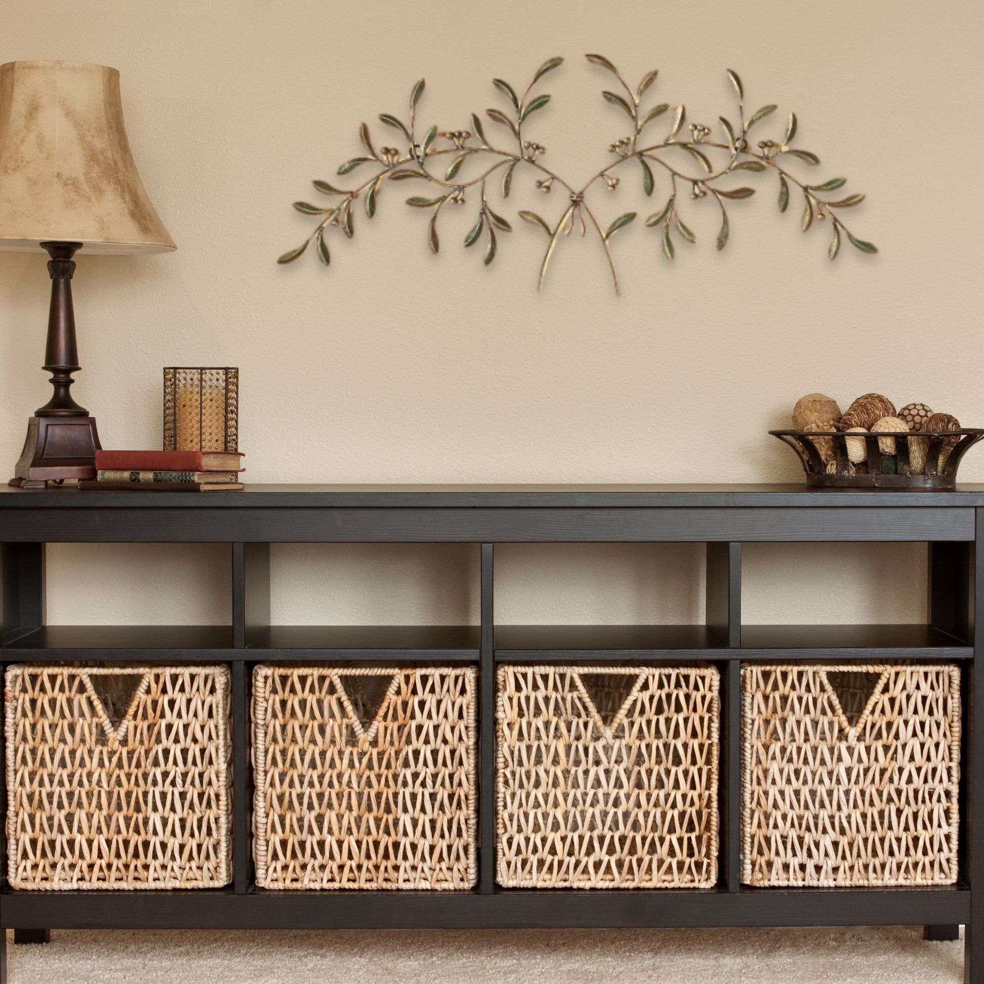 Red, Green, Gold Olive Leaf Iron Wall Grille - Olive Branch Metal Wall Decor (42.5"W) hung over console table with wicker baskets | oak7west.com