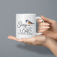 White mug with 'Sing to the LORD a new song' text and bird illustration held by hands against a gray background | oak7west.com