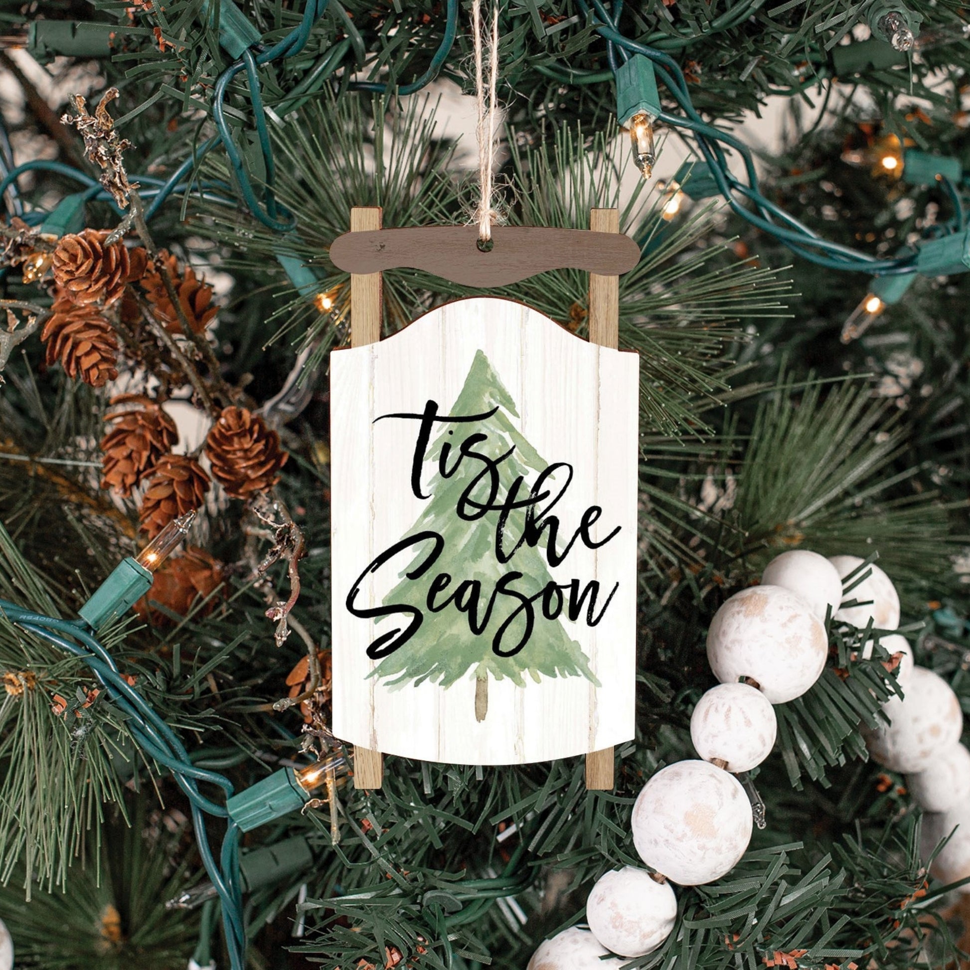 Decorative Christmas ornament with 'tis the Season' text on a Christmas tree | Sled Shaped Christmas Ornament | oak7west.com