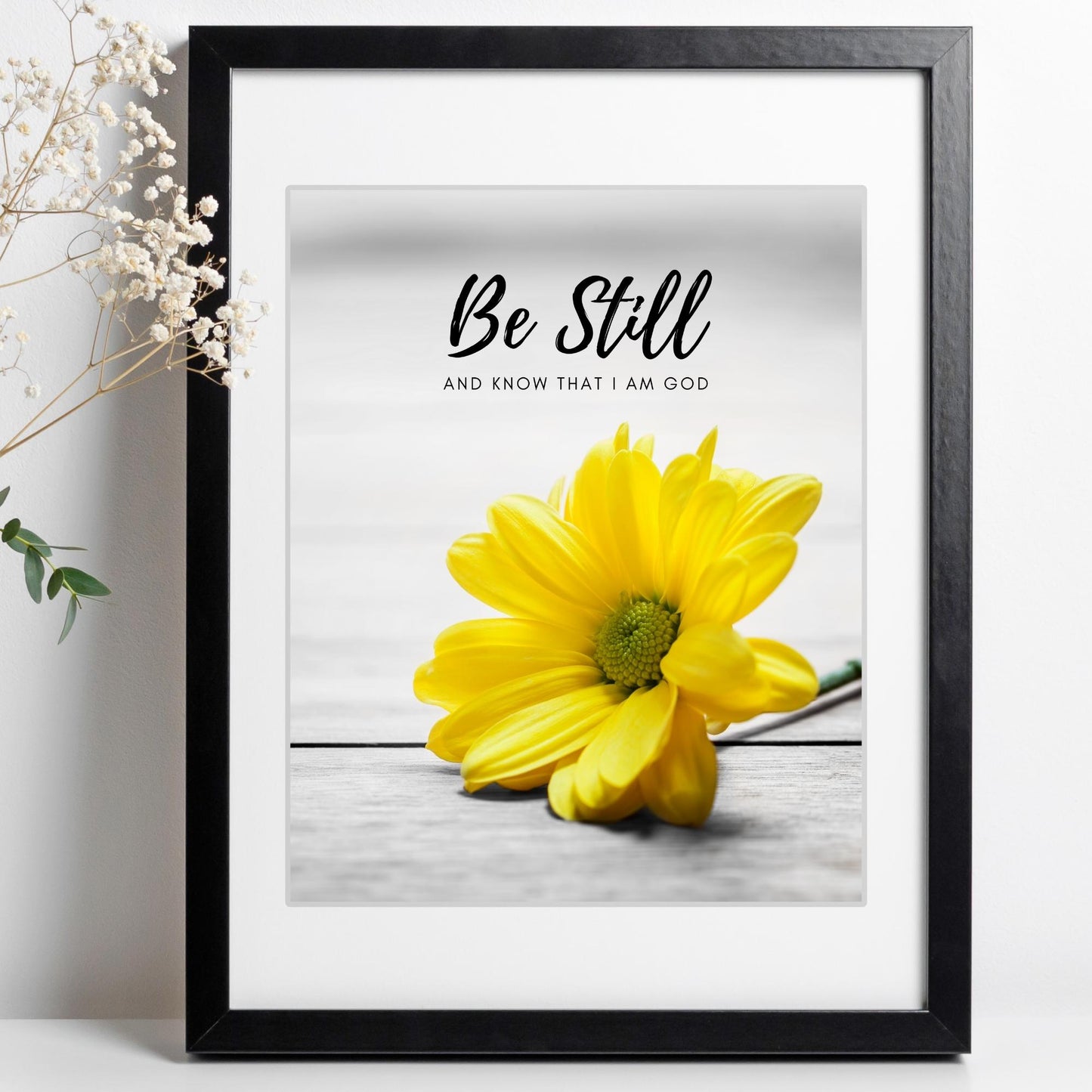Inspirational Word Art - Be Still and know that I am God - Yellow Daisy Wall Decor (8x10 print) | bible verse Psalm 46:10 wall decor in black frame on white wall next to babys breath | oak7west.com
