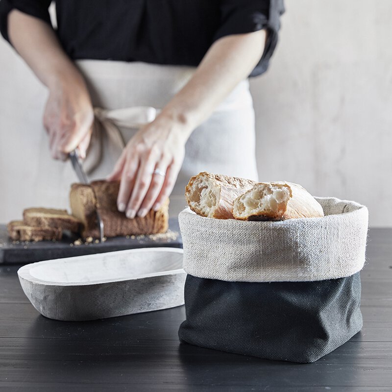 Linen Bread Pouch - Grey & Black Reversible (woman cutting bread next to linen bread bag with warm bread waiting for dinner guests) | oak7west.com