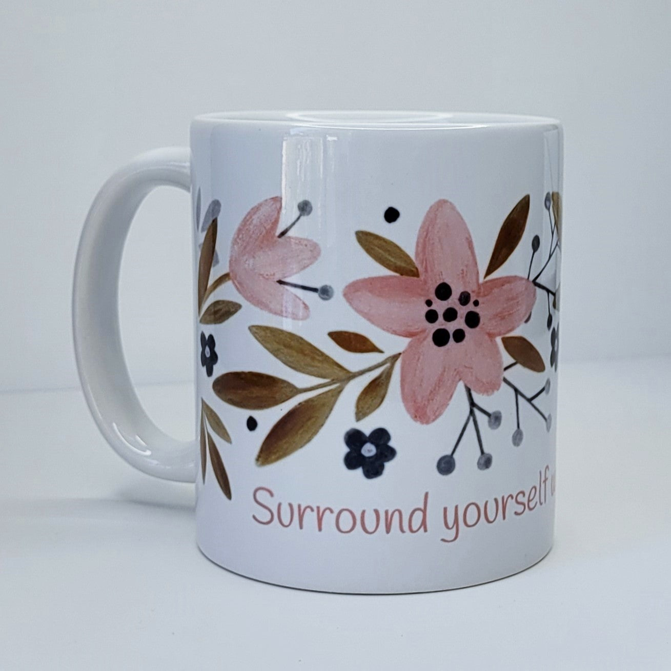 Surround yourself with what you love coffee mug (exclusive design) | lovely crisp white with a floral print in pinks, tans, and navy blue, finished off with the words "Surround yourself with what you love" in a fun pink font | 11 ounce coffee cup | oak7west.com