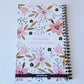 Our exclusive notebook designed in-house has a cute floral print in pinks, tans, and navy blue. The cover reads "Surround yourself with what you love" in a fun pink font. The floral design also decorates the back cover with the words "be a blessing... today, tomorrow, always".  | oak7west.com