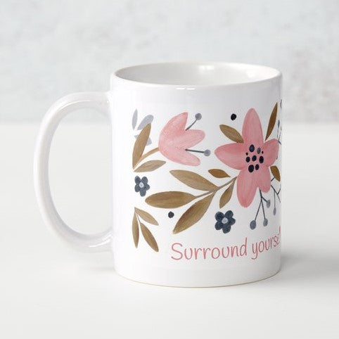 Surround yourself with what you love coffee mug (exclusive design) | lovely crisp white with a floral print in pinks, tans, and navy blue, finished off with the words "Surround yourself with what you love" in a fun pink font | 11 ounce coffee cup | oak7west.com